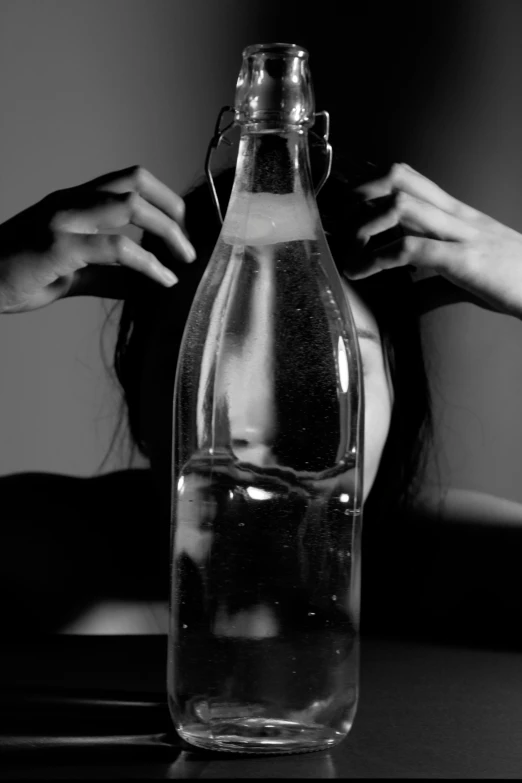 a woman reaches for a bottle of water