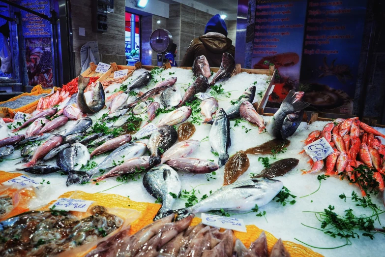 an indoor fish market has many different seafood