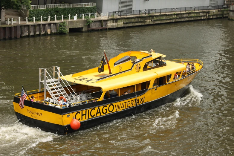 a yellow chicago water taxi boat rides in the river