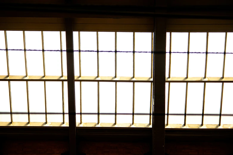 some light is coming through a window by the bars