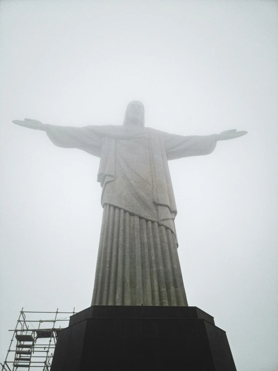 foggy overcast sky with a statue in front