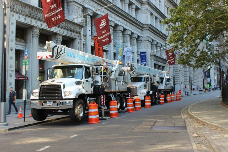 a line of trash trucks parked next to each other