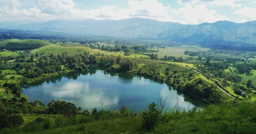 large lake nestled in a grassy mountain valley