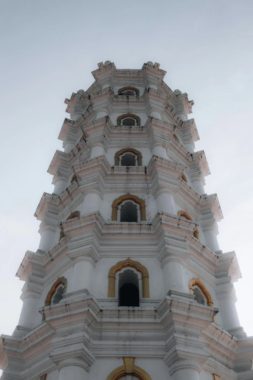 a clock on the top of a white building