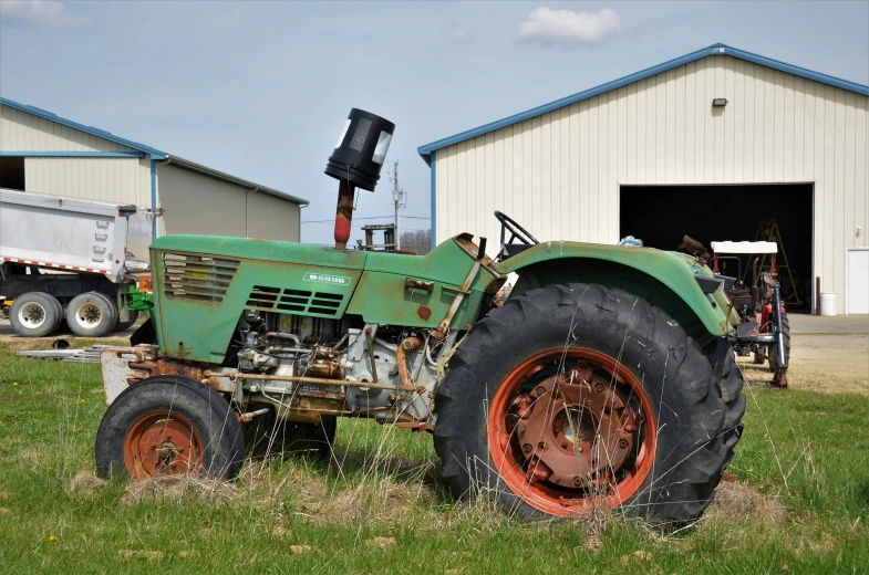 there is an old tractor in a yard