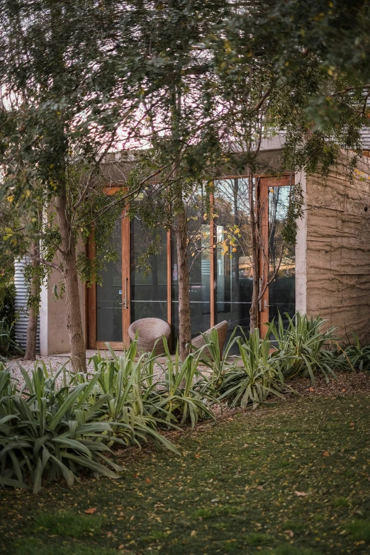 the patio has an open window with multiple panes and a small couch