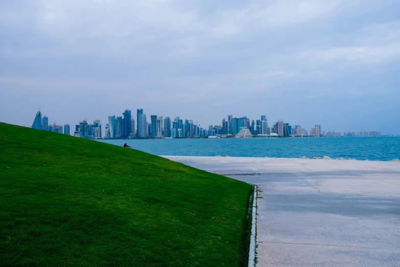 an empty park overlooking the city skyline in the ocean