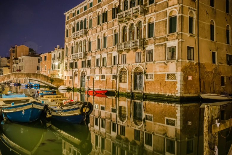 several boats are docked at the dock outside a building