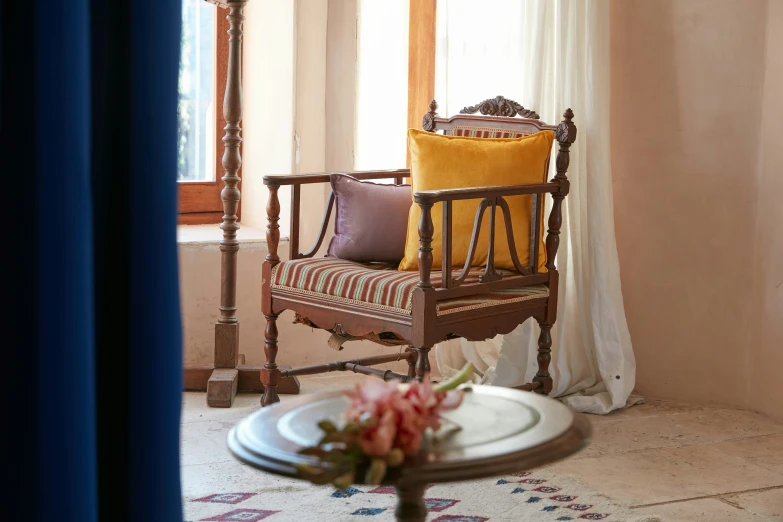 a small table with two flowers and a plate sitting on top of it