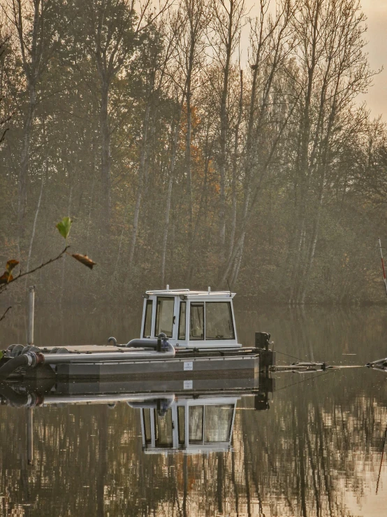 a small boat on the water near some trees