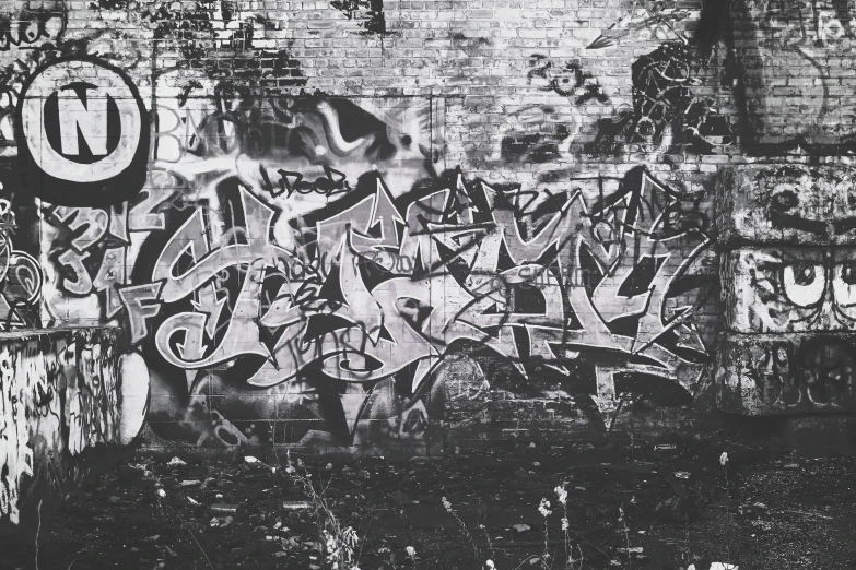 a black and white po of graffiti on a wall