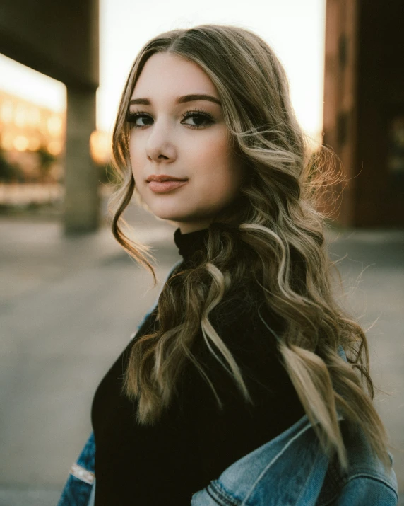 a woman standing with her hand on her hip and looking off into the distance