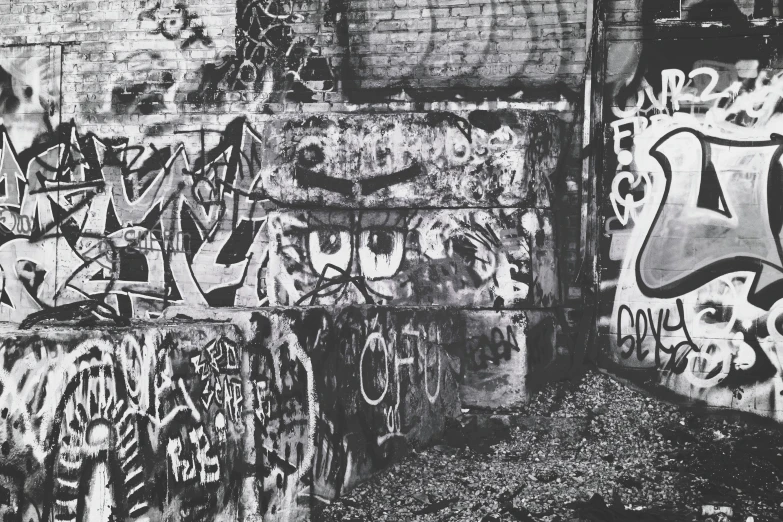 black and white pograph of wall with graffiti