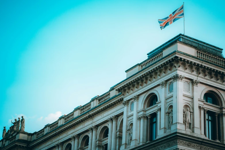 an old building is with a very large flag