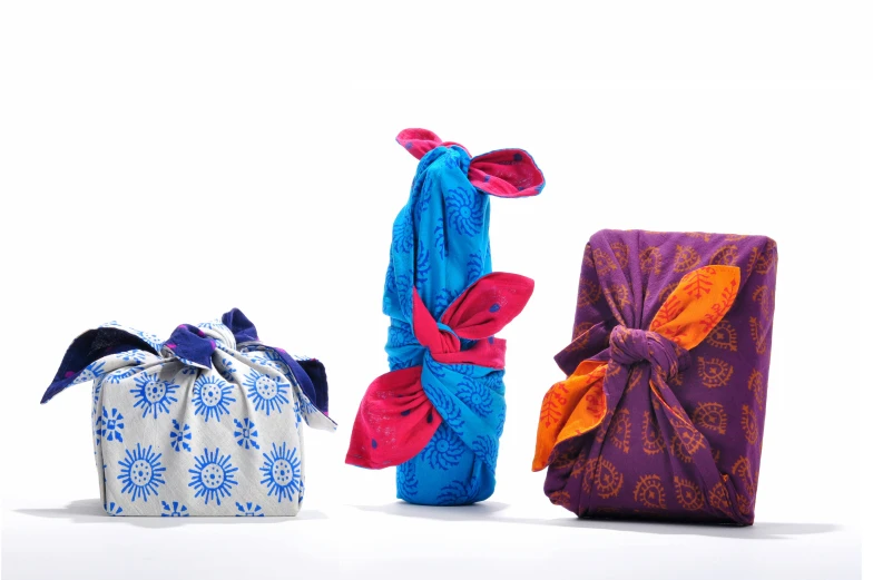 three pieces of cloth wrapped in varying fabrics