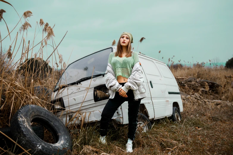 there is a woman sitting on the front of a white van