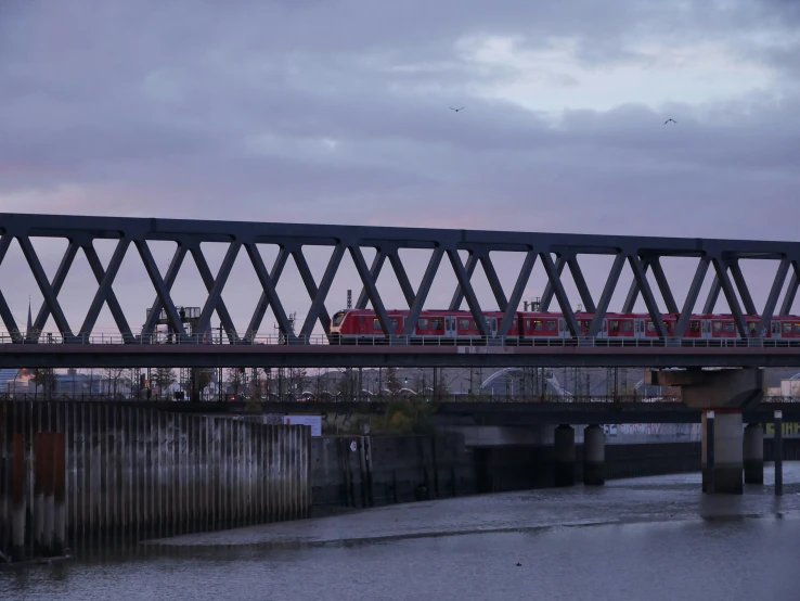 a train traveling over a bridge in the rain