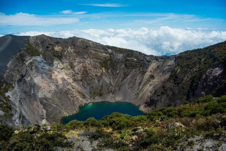 a large blue lake sitting in the middle of a mountain