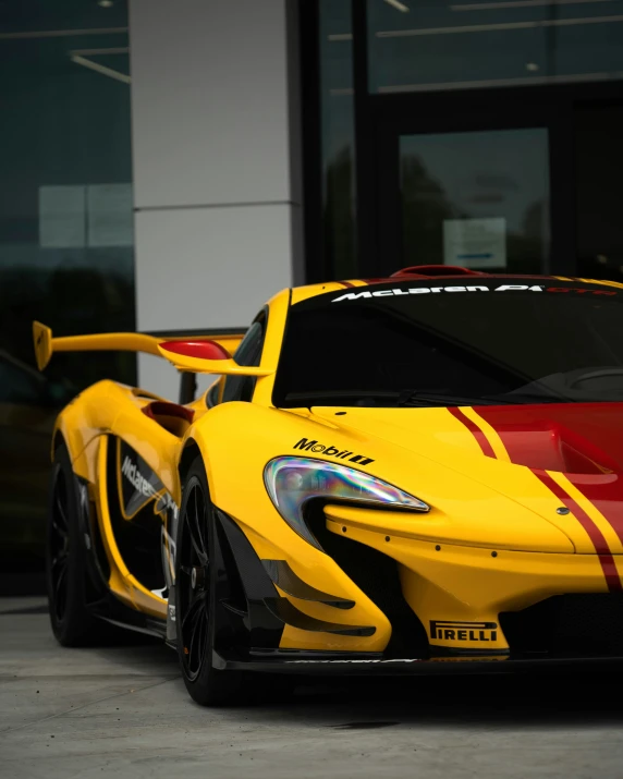an all yellow sport car with two red stripes on it
