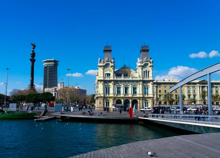 the waterfront has people walking and birds bathing