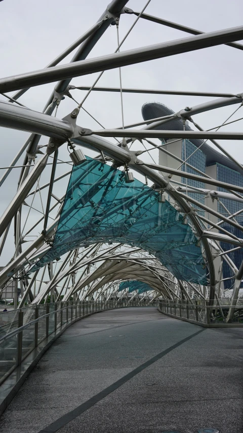 a metal structure next to a building with a glass roof