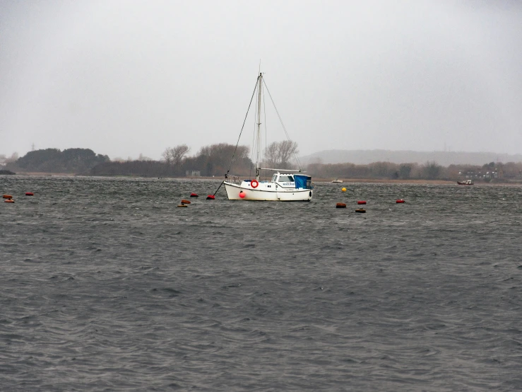 a small boat is sailing in the middle of some water