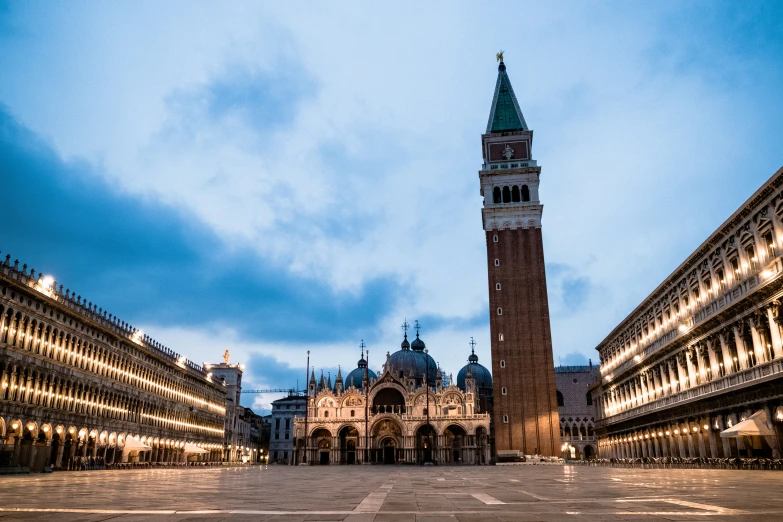 clock tower in an old european square with a dark sky