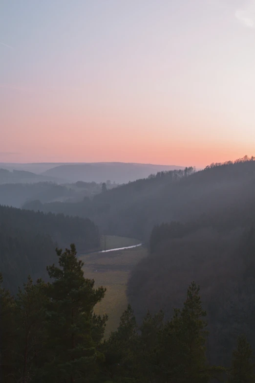 a scenic sunset over a mountain covered in mist