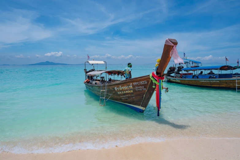 two wooden boats at the water's edge