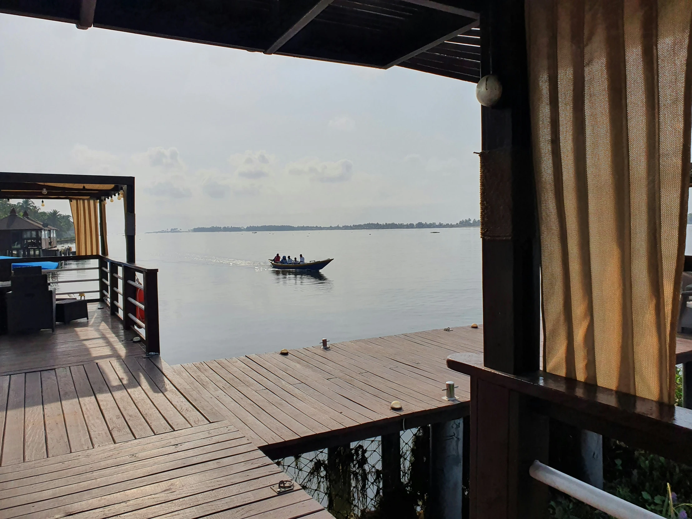 a boat travels on the water near a small dock