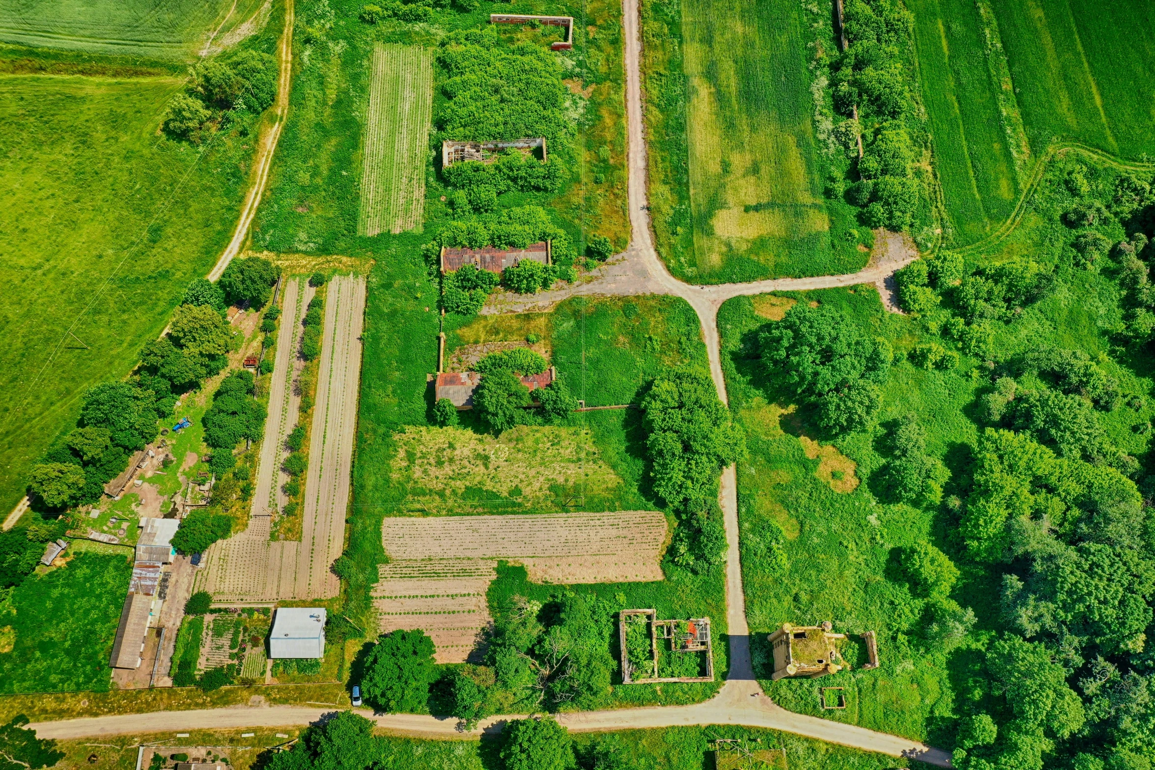 a farm field surrounded by trees and grass