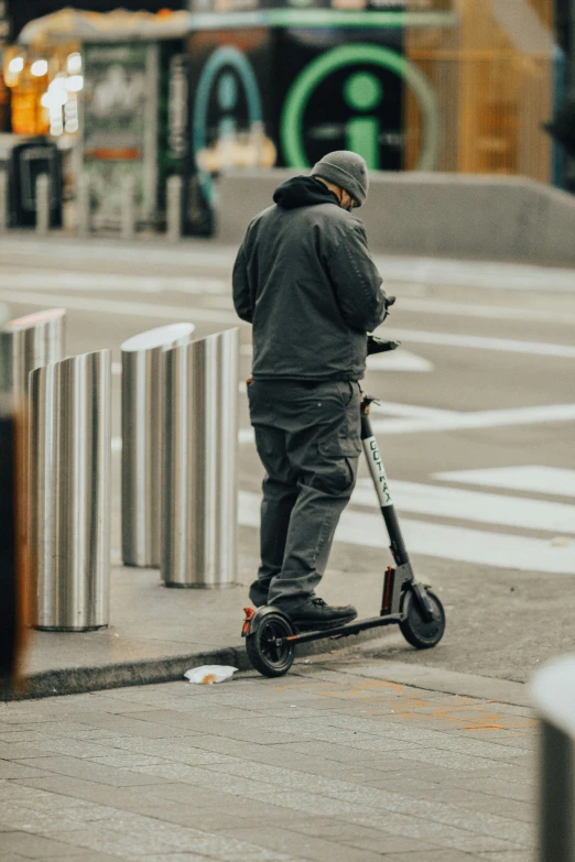 a young man is riding an adult scooter