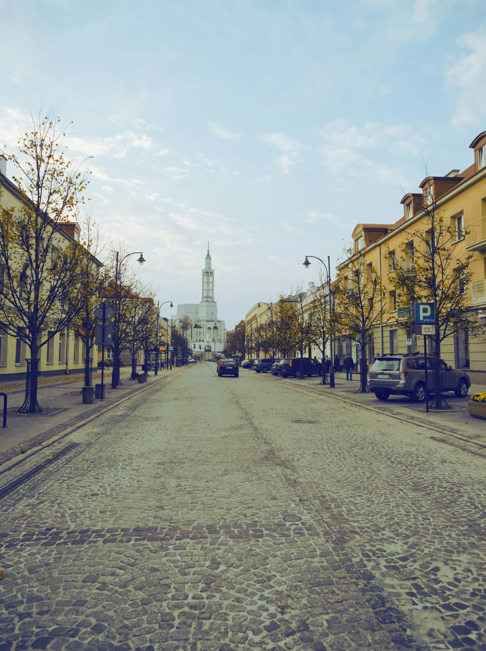 a street filled with lots of trees next to tall buildings