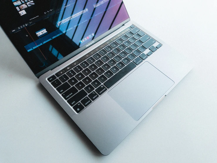 a laptop with a silver keyboard on a white surface