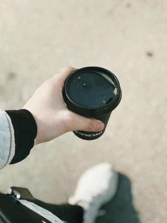 a person holds up an empty paper cup