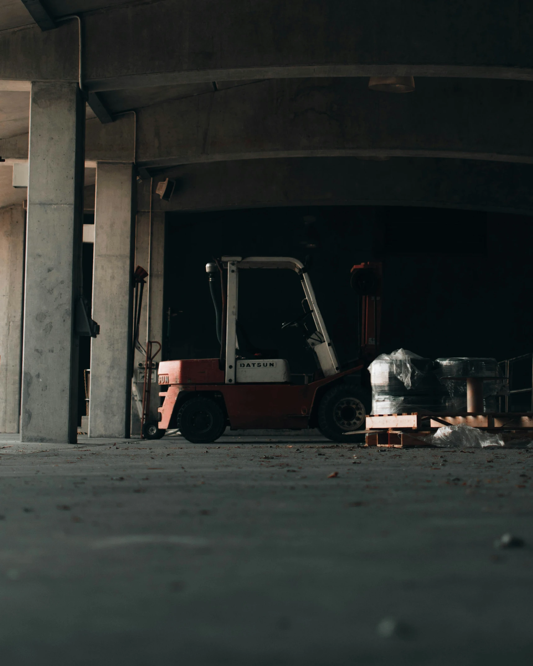 the forklift is in an empty parking garage