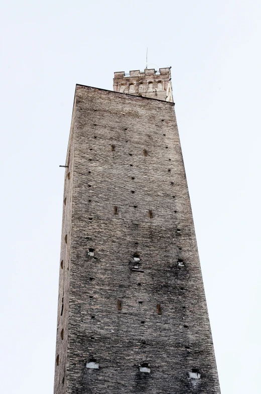 a brick tower with a large clock on it's face