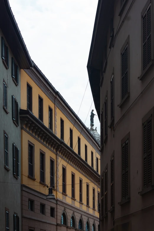 a tall building with a clock mounted on the side