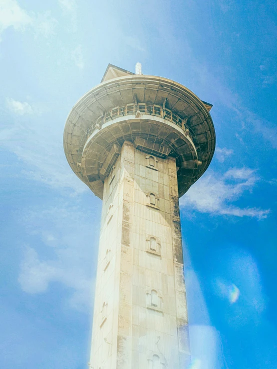 the top of a tall tower with people walking around