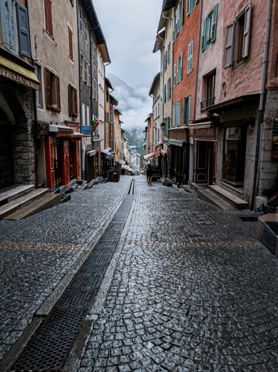 a narrow street with a few cobblestones
