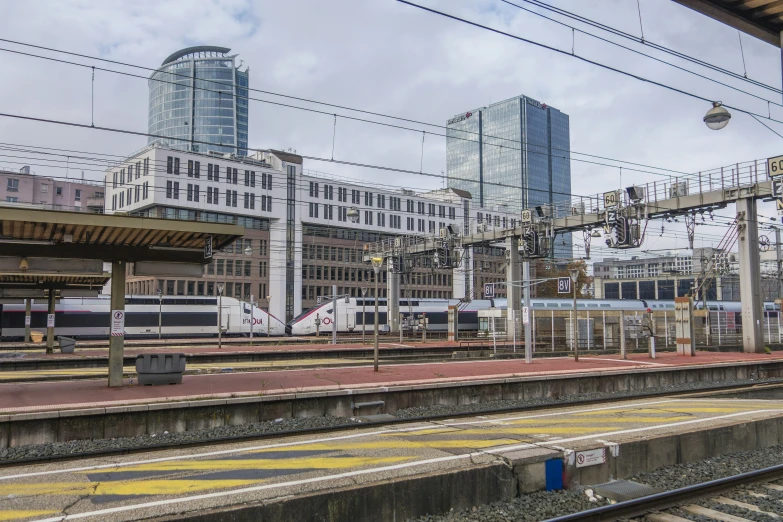 the view from inside of the train station, showing a train on the track