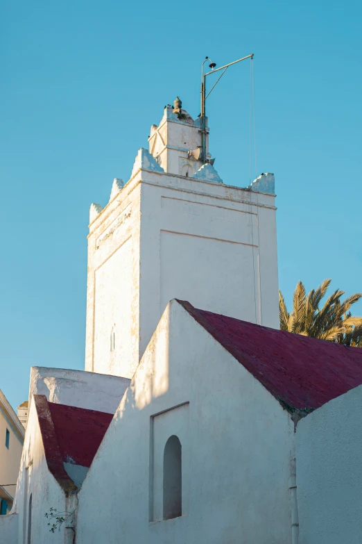 the old church has a red roof and is surrounded by tall buildings