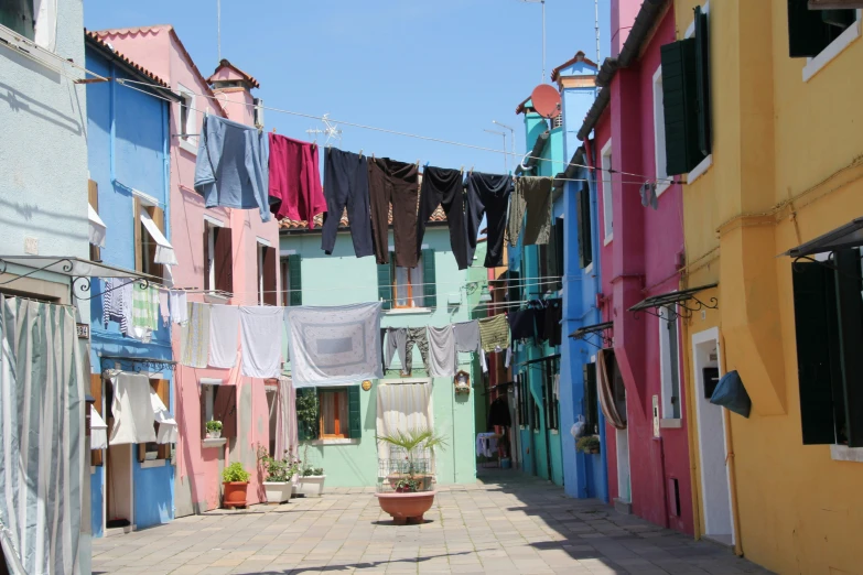 a number of buildings with a string of clothes