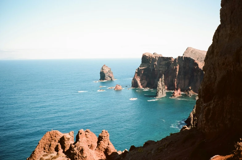 rocky cliffs overlooking the ocean with an arch