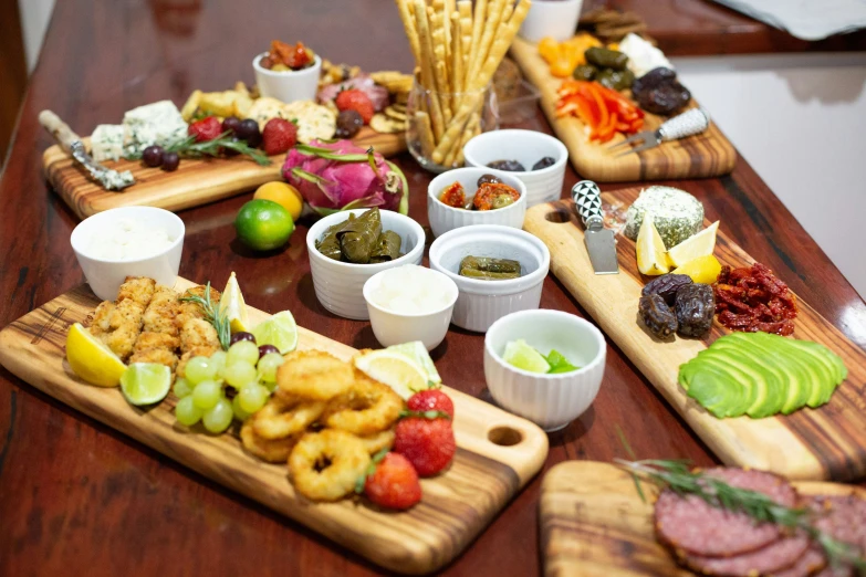 a wood table topped with several plates of food