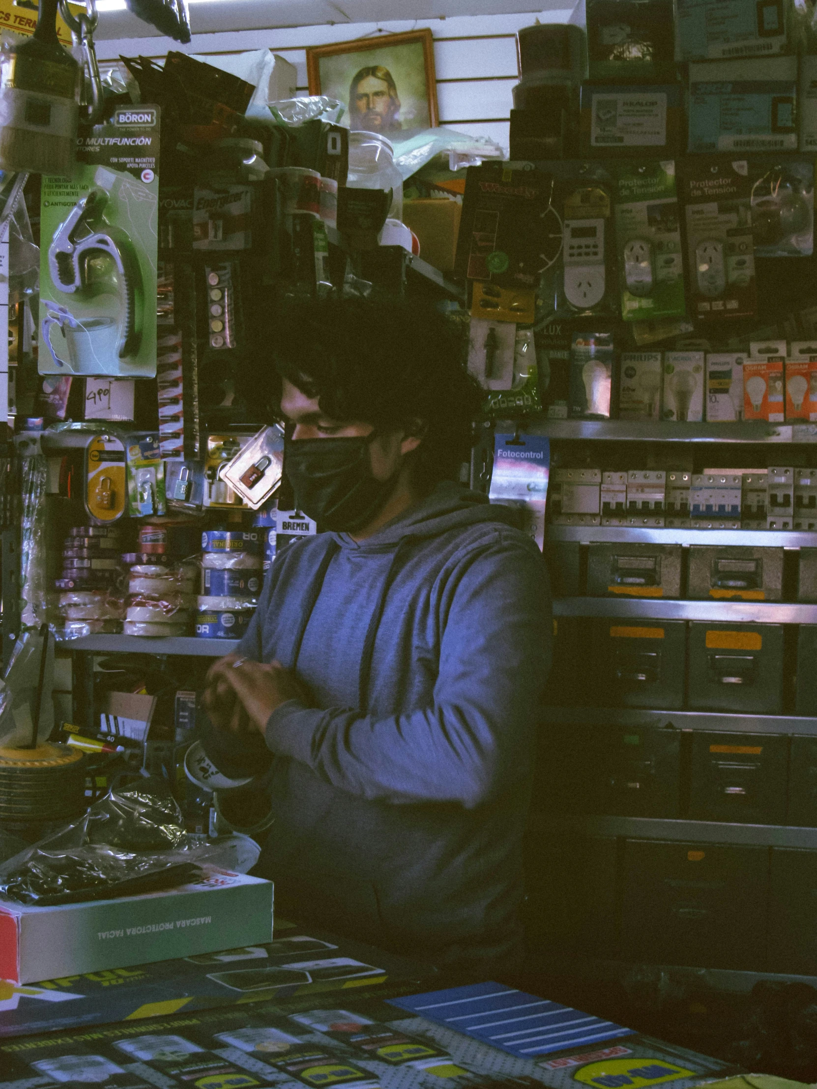 a man standing next to a display of various items