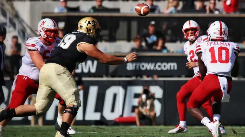 a football player throws a pass during the game