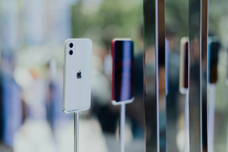 three different sizes of cell phones, standing next to each other