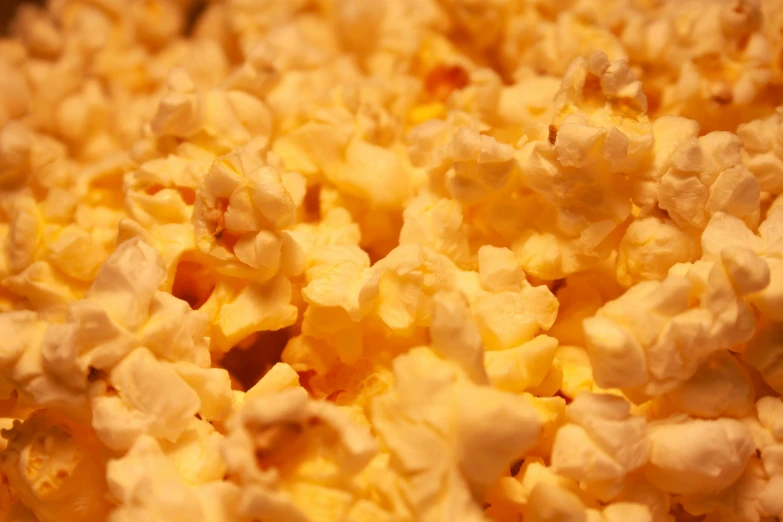 closeup of popcorn sitting next to another closeup of soing