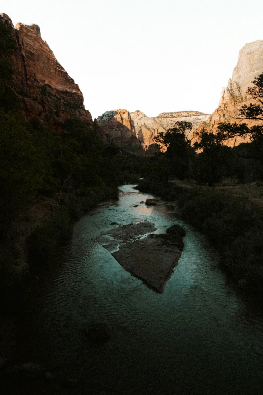 a heart shaped river in the middle of mountains